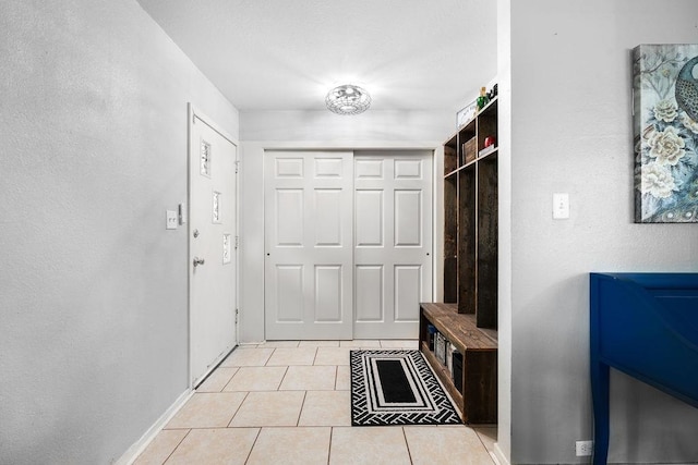 mudroom featuring light tile floors