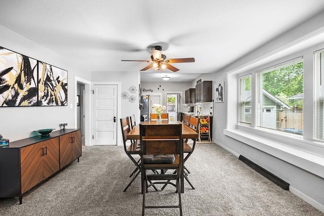 carpeted dining space featuring ceiling fan