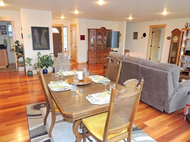 kitchen with high vaulted ceiling, stainless steel appliances, a center island with sink, and pendant lighting