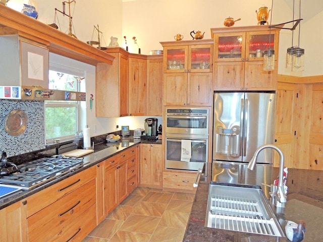 35025 Mourning Dove Ln N, Davenport, WA 99122 - kitchen with appliances with stainless steel finishes, a sink, glass insert cabinets, dark stone counters, and pendant lighting