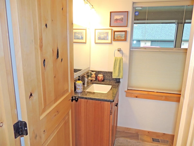 bathroom with vanity with extensive cabinet space, double sink, and tile flooring