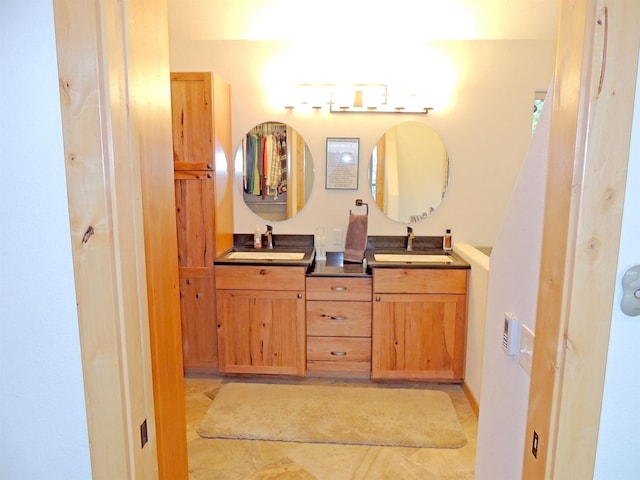 bathroom featuring tile floors, vanity with extensive cabinet space, and double sink