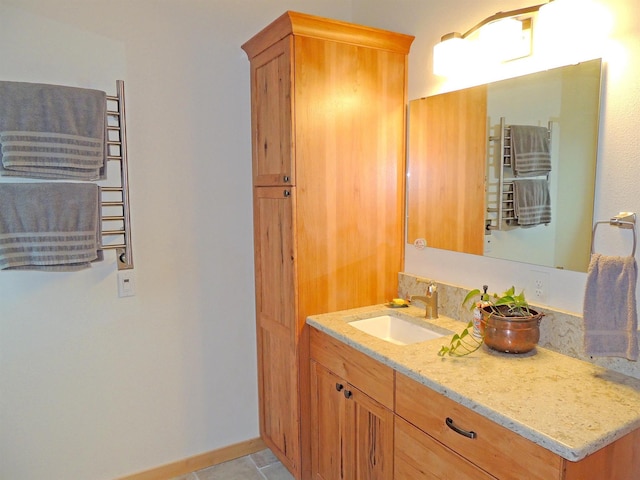 35025 Mourning Dove Ln N, Davenport, WA 99122 - bathroom featuring a towel warmer, vanity, and baseboards