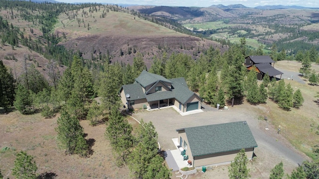 35025 Mourning Dove Ln N, Davenport, WA 99122 - aerial view of property's location featuring a mountain backdrop and a forest