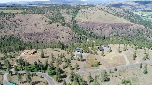 35025 Mourning Dove Ln N, Davenport, WA 99122 - aerial view of property and surrounding area with a mountainous background and a heavily wooded area