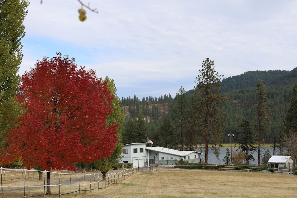 view of yard featuring a water view and a rural view