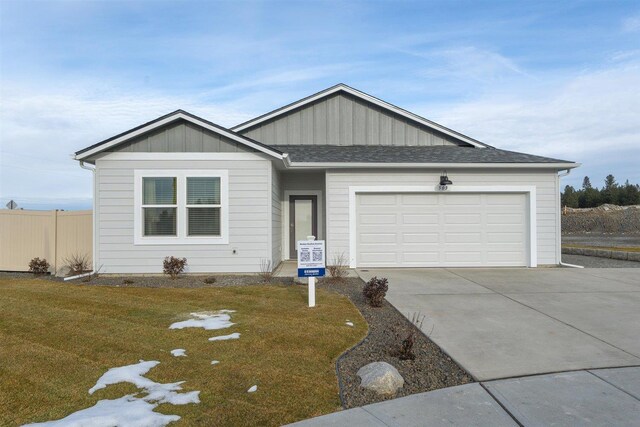 view of front of house featuring a garage and a front yard