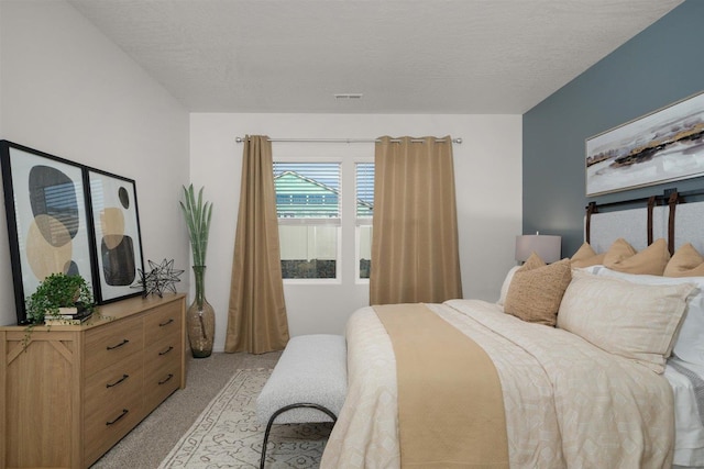 carpeted bedroom with a textured ceiling