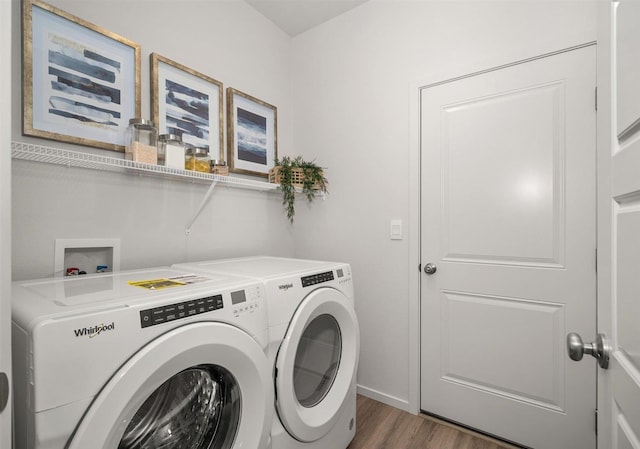 laundry area with dark hardwood / wood-style flooring and independent washer and dryer