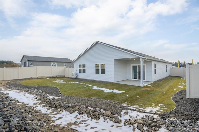 snow covered property featuring a lawn and a patio