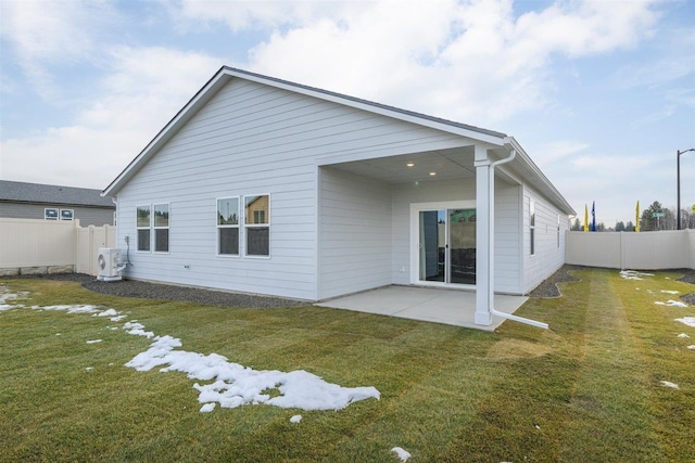 back of property with ac unit, a patio area, and a yard