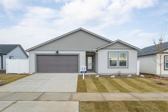 ranch-style house featuring a garage and a front lawn