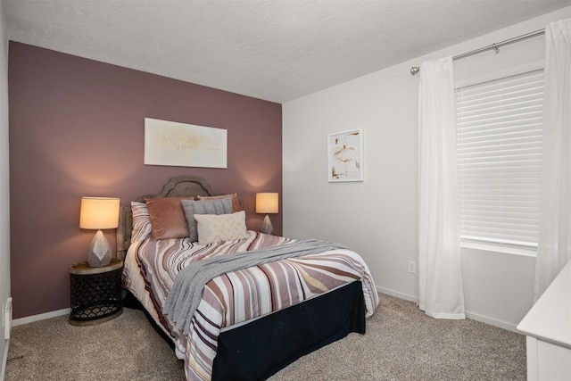 carpeted bedroom featuring a textured ceiling