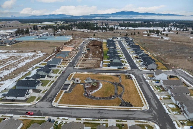 snowy aerial view featuring a mountain view