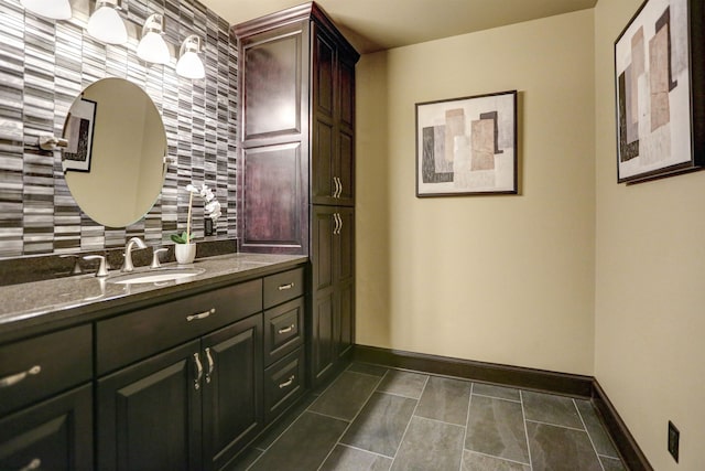 bathroom featuring vanity, tasteful backsplash, and tile floors