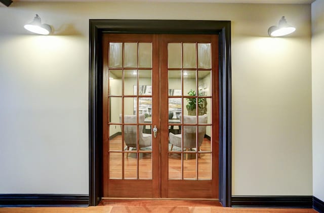 doorway to outside with french doors and light carpet