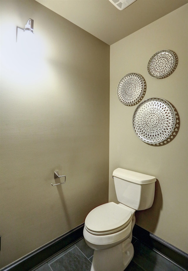 bathroom with tile floors and toilet