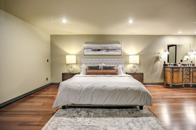 bedroom with dark hardwood / wood-style flooring