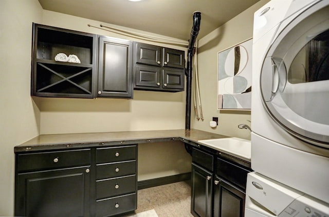 interior space featuring sink, stacked washing maching and dryer, and light tile floors