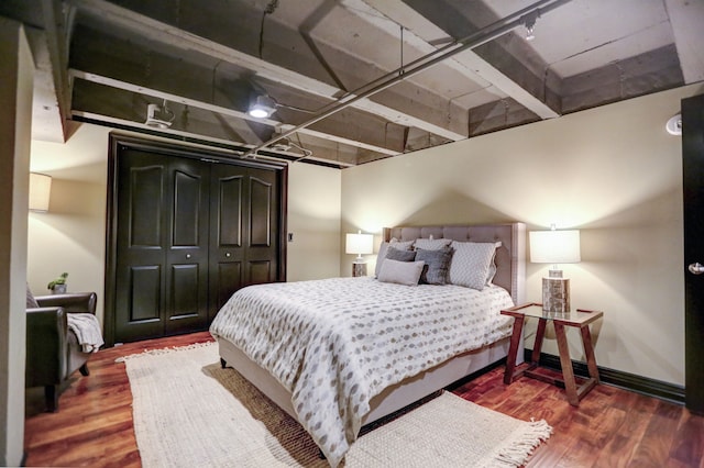 bedroom with a closet and dark hardwood / wood-style floors