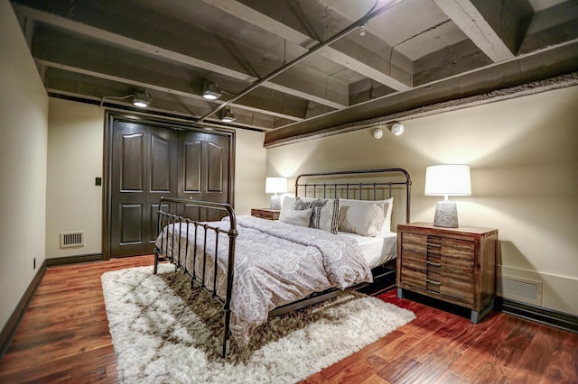 bedroom with dark wood-type flooring