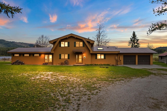 view of front property with a garage and a yard