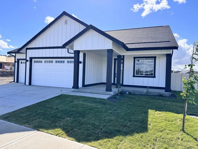 view of front of property featuring a garage and a front lawn