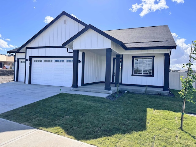 view of front of house featuring a porch, a garage, and a front yard