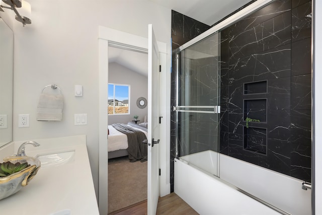 bathroom with vanity, wood-type flooring, and combined bath / shower with glass door