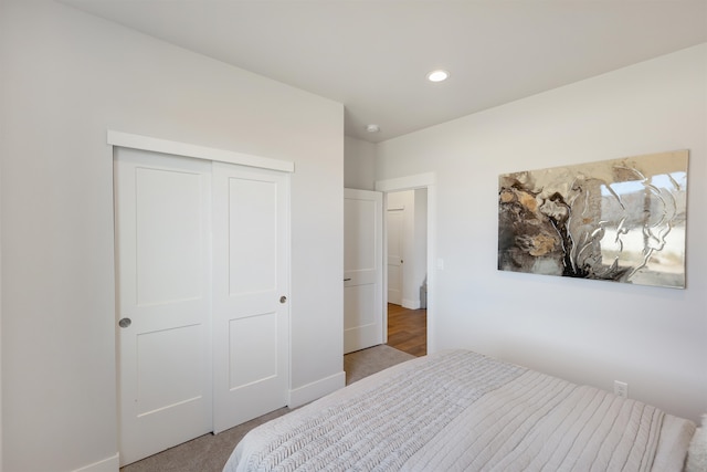 bedroom with carpet and a closet