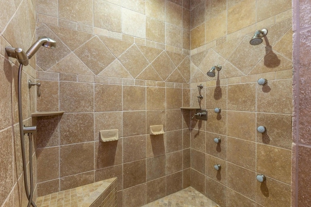 bathroom with a tile shower