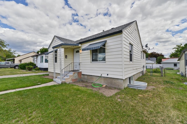 bungalow-style home featuring a front yard