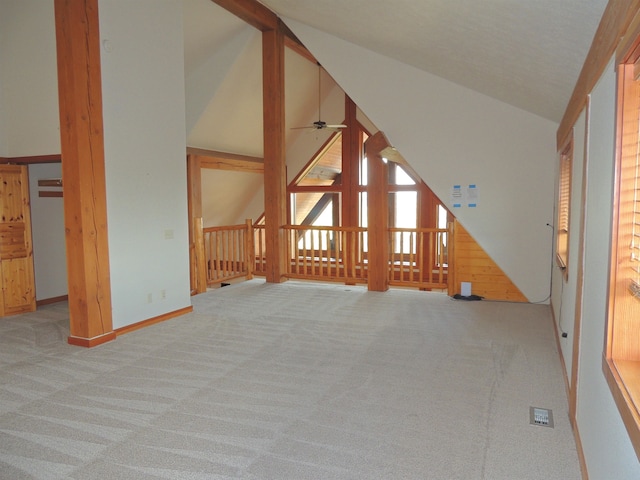 interior space featuring carpet flooring, ceiling fan, and vaulted ceiling