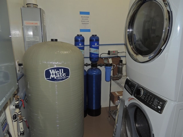 laundry room featuring stacked washer / drying machine