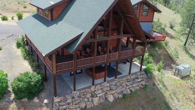 rear view of house featuring a wooden deck