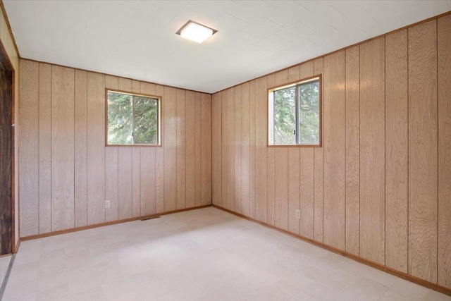 empty room featuring wooden walls