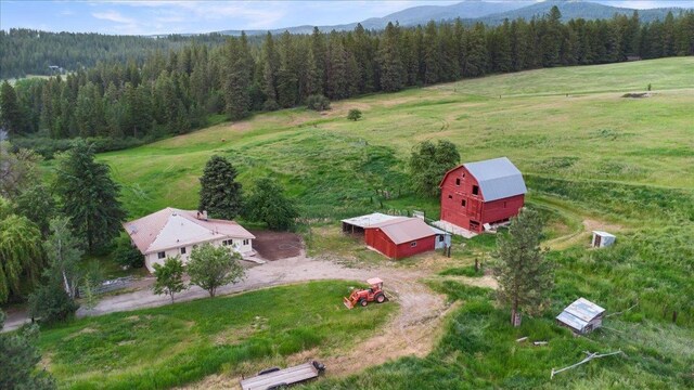 birds eye view of property with a rural view