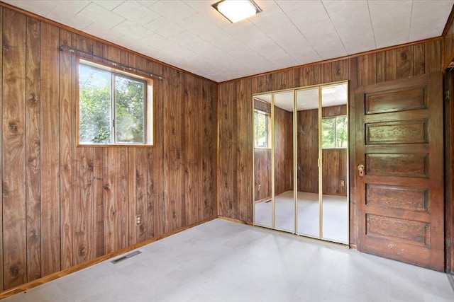 spare room featuring wooden walls