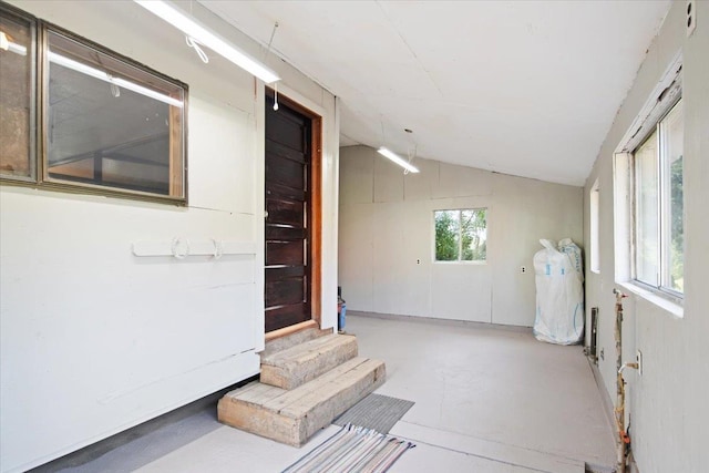 interior space with concrete flooring and vaulted ceiling