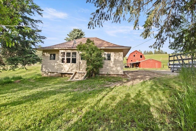 rear view of house with a yard