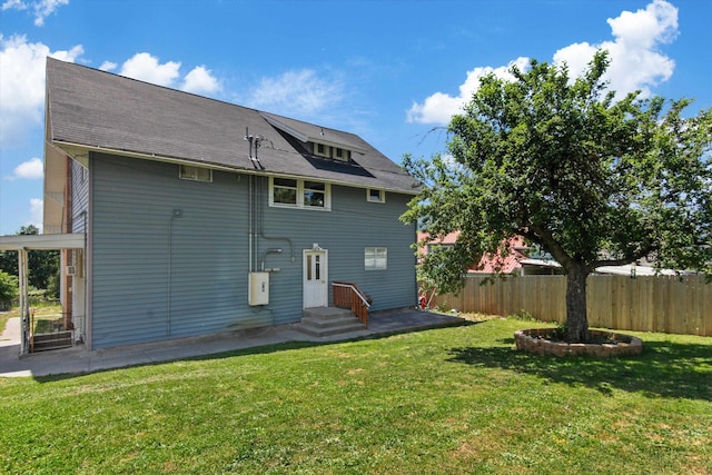 back of property featuring a patio and a lawn