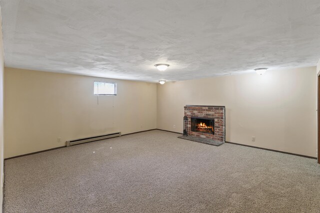 basement featuring carpet floors, baseboard heating, and a brick fireplace