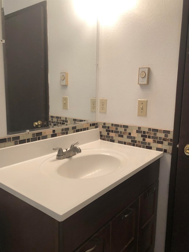 bathroom with backsplash and vanity