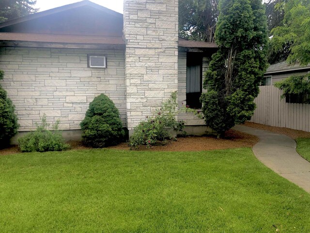 view of side of home featuring a yard