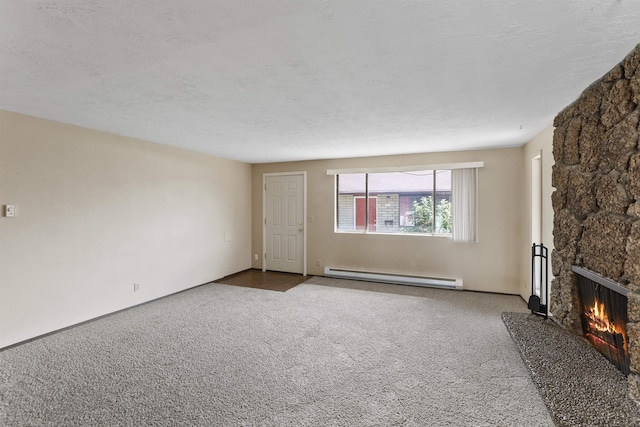 unfurnished living room featuring carpet, a baseboard radiator, a textured ceiling, and a fireplace