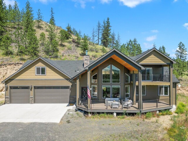 view of front of property featuring a garage and a balcony