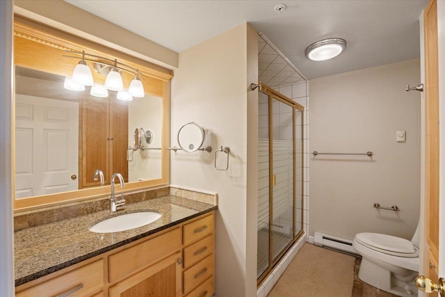 bathroom with toilet, vanity, an enclosed shower, and a baseboard heating unit