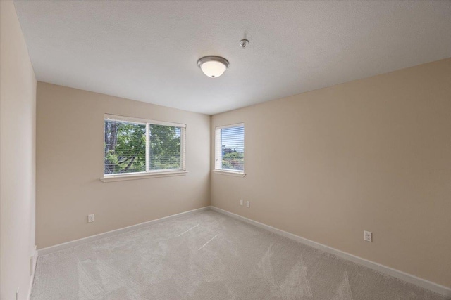 empty room featuring light colored carpet