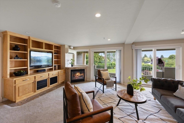 living room featuring light carpet and a wall mounted air conditioner