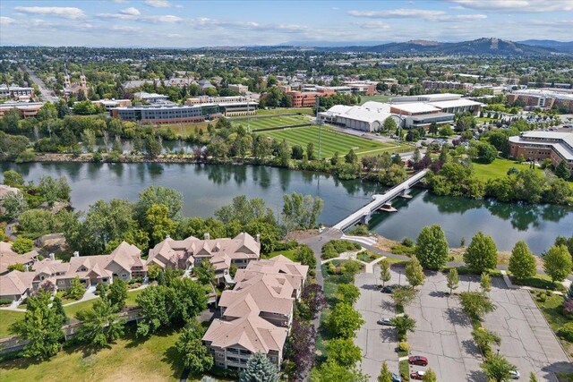 birds eye view of property with a water and mountain view